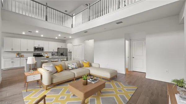 a living room with furniture and kitchen view