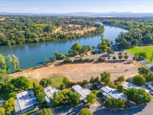 an aerial view of a houses with a lake view