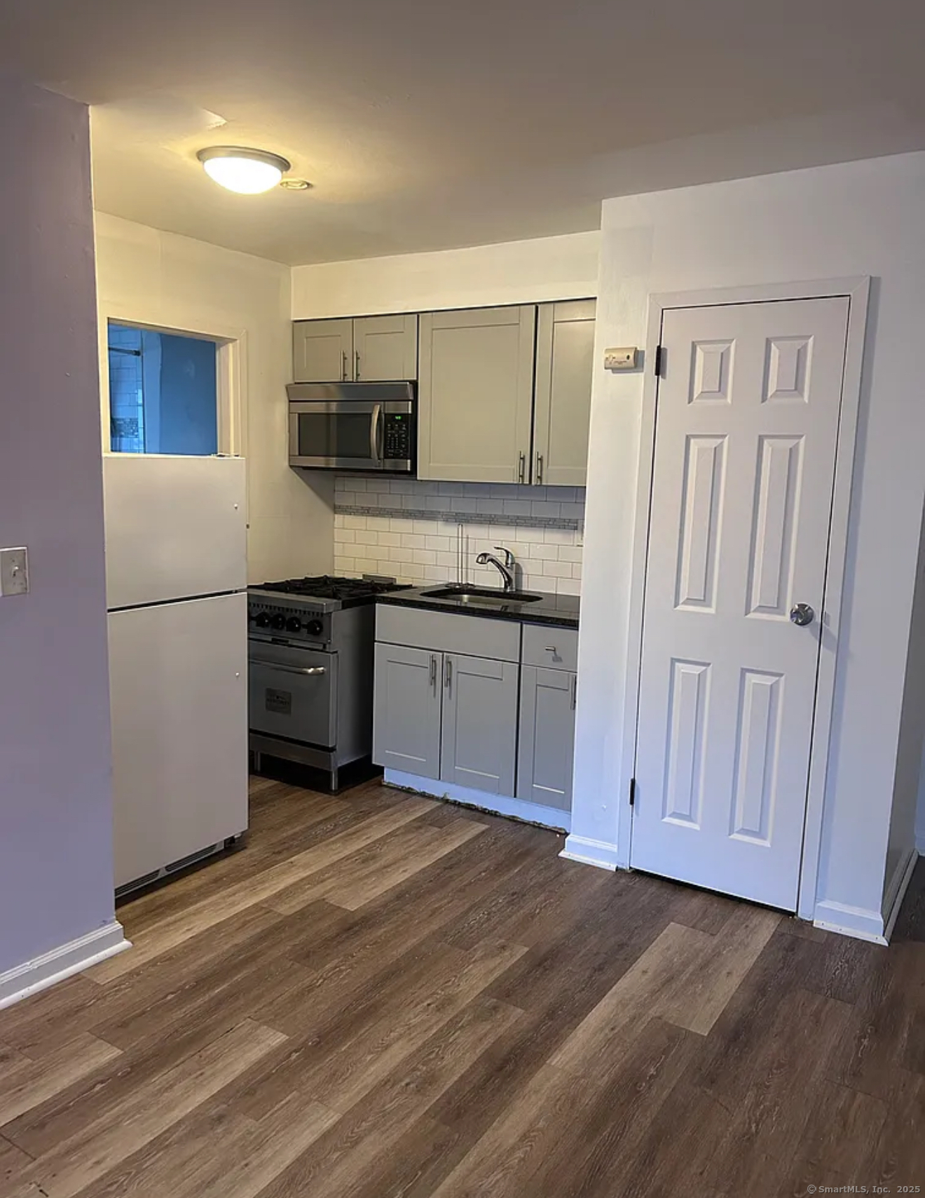 a kitchen with stainless steel appliances granite countertop a refrigerator and a sink