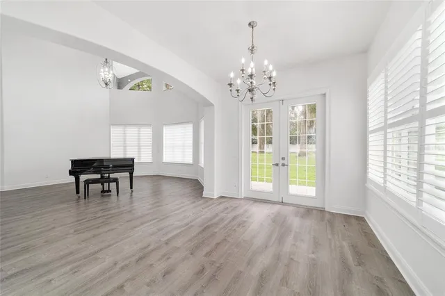 a view of empty room with wooden floor and fireplace