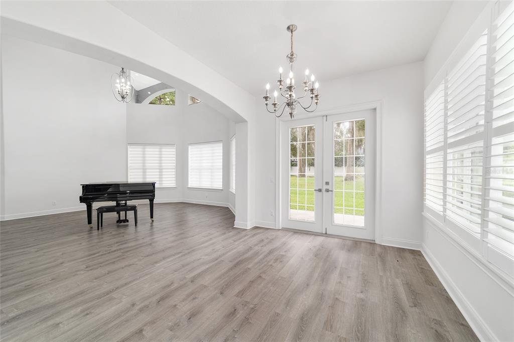 1718 Southwest 27th Street Ocala, FL 34471 - Photo 12 of 91 a view of empty room with wooden floor and fan