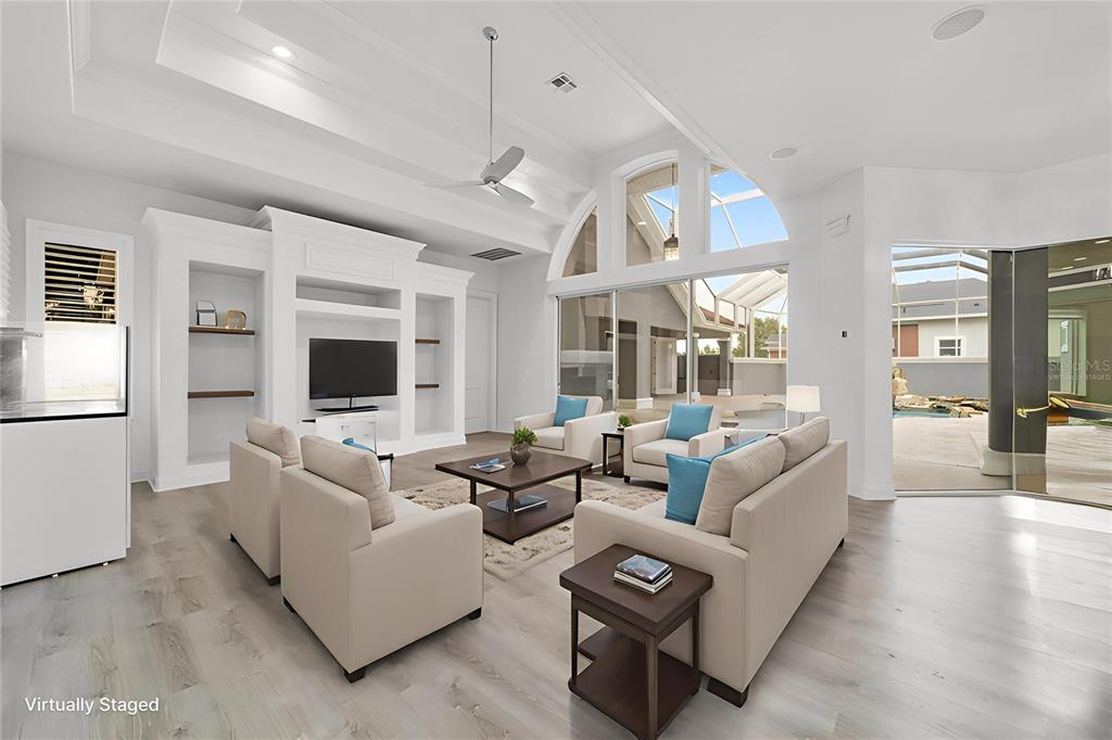 1718 Southwest 27th Street Ocala, FL 34471 - Photo 25 of 91 a living room with furniture a flat screen tv and a large window