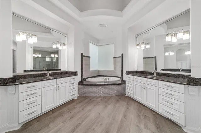 a view of a hallway with closet and a chandelier fan