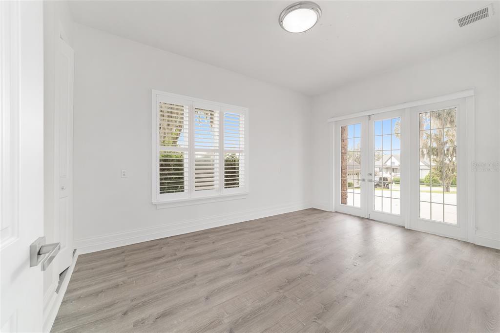 1718 Southwest 27th Street Ocala, FL 34471 - Photo 58 of 91 an empty room with wooden floor and windows