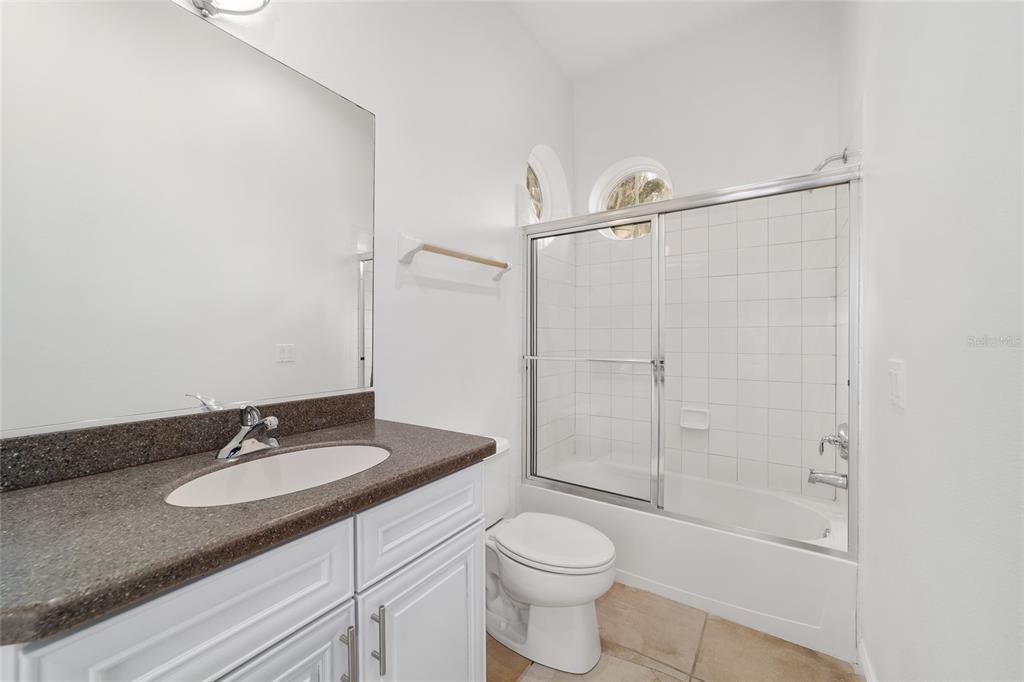 1718 Southwest 27th Street Ocala, FL 34471 - Photo 73 of 91 a bathroom with a granite countertop sink toilet and shower