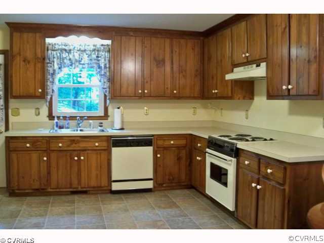 14218 River Road Chesterfield, VA 23838 - Photo 5 of 7 a kitchen with stainless steel appliances granite countertop a stove a sink dishwasher and a microwave oven with large trees