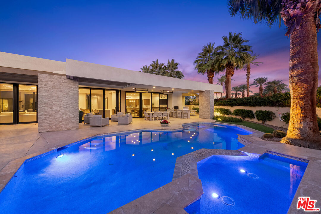a swimming pool with outdoor seating