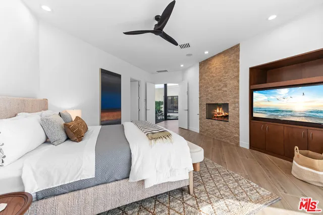 a bedroom with a large bed and a flat screen tv