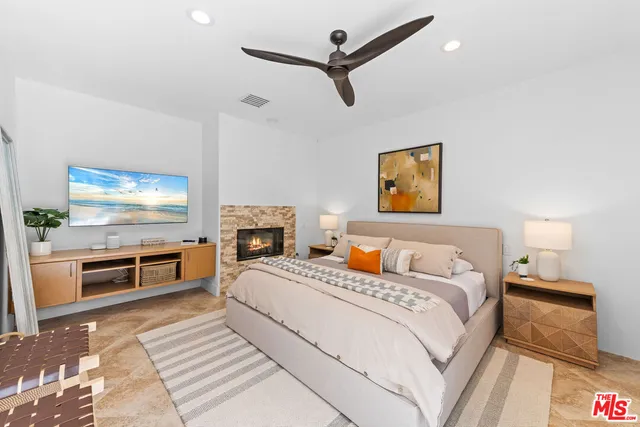 a bedroom with a bed and a flat screen tv