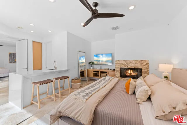 a bedroom with furniture and a fireplace