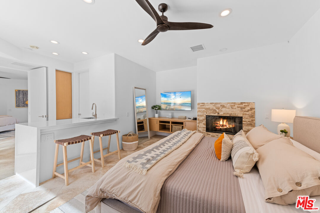 79400 Stonegate La Quinta, CA 92253 - Photo 26 of 46 a bedroom with furniture and a fireplace