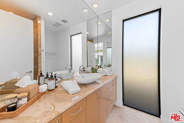 a bathroom with a double vanity sink and mirror