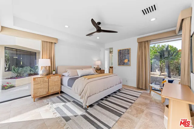 a spacious bedroom with a large bed and a large window