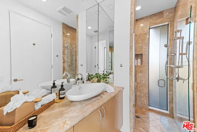 a bathroom with a granite countertop sink and a mirror