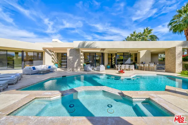 a view of swimming pool with outdoor seating
