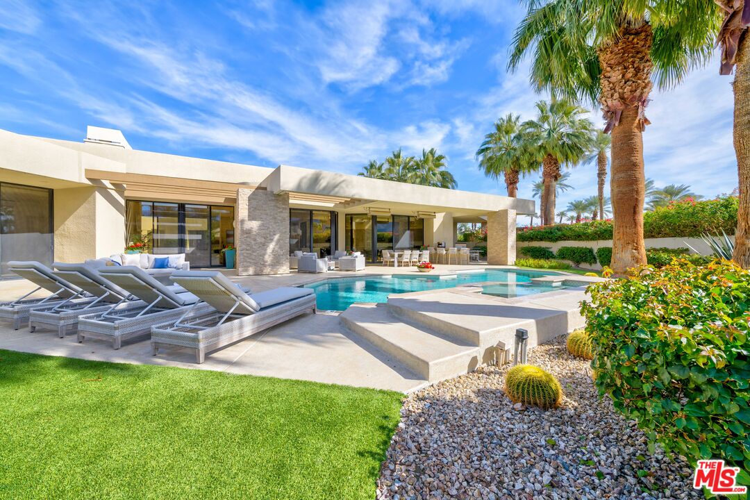 79400 Stonegate La Quinta, CA 92253 - Photo 34 of 46 a front view of a house with garden and porch