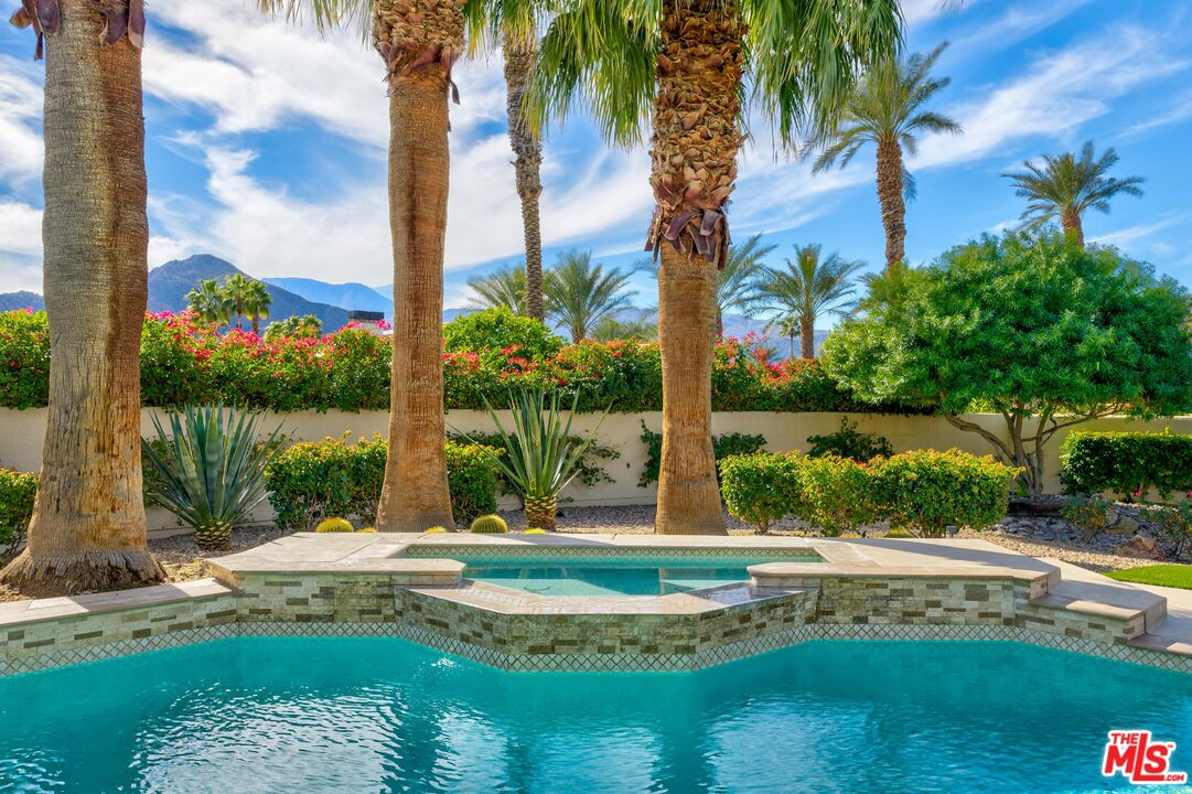 79400 Stonegate La Quinta, CA 92253 - Photo 35 of 46 a view of a swimming pool with a yard and palm trees