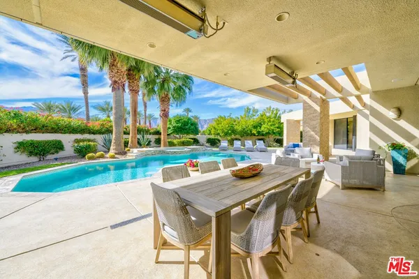 a view of an outdoor space with furniture and garden