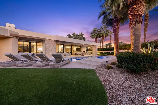 a view of a house with backyard porch and sitting area