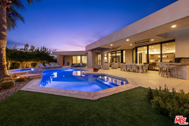 a view of swimming pool with outdoor seating