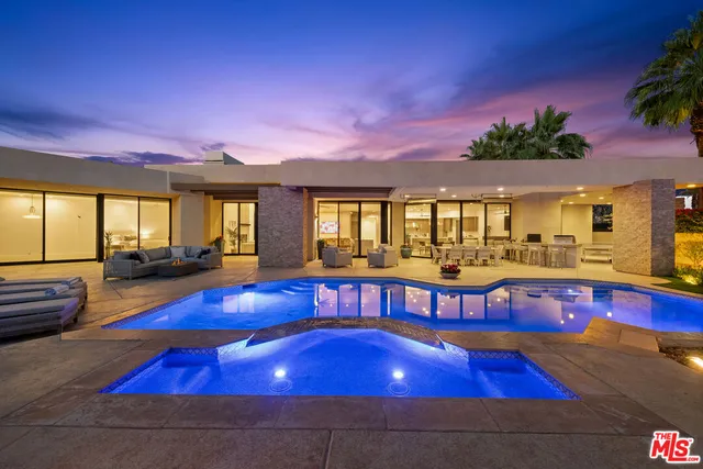 a swimming pool with outdoor seating