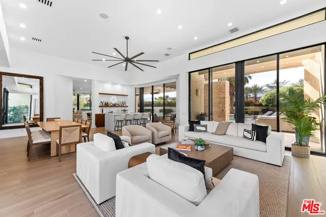 a living room with furniture and large windows