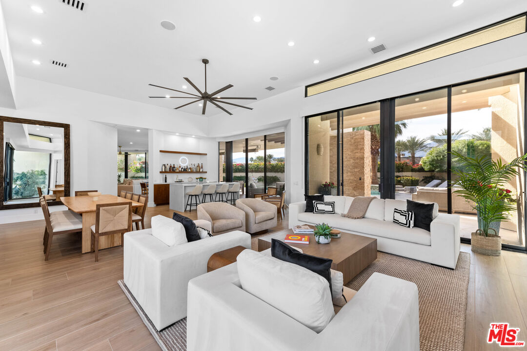 79400 Stonegate La Quinta, CA 92253 - Photo 5 of 46 a living room with furniture and large windows