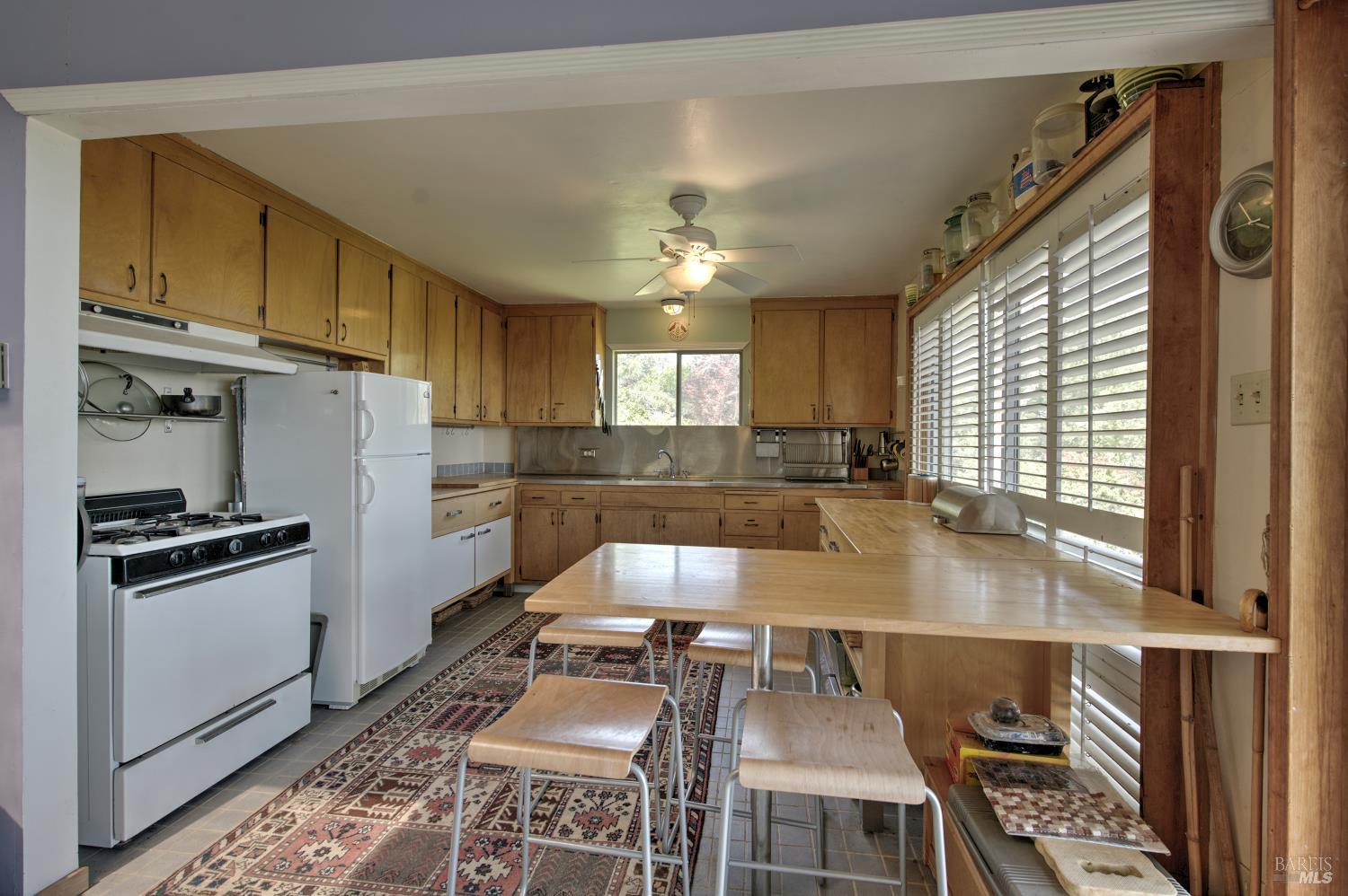 10957 Westside Road Healdsburg, CA 95448 - Photo 10 of 30 a kitchen with granite countertop a stove a sink and a refrigerator