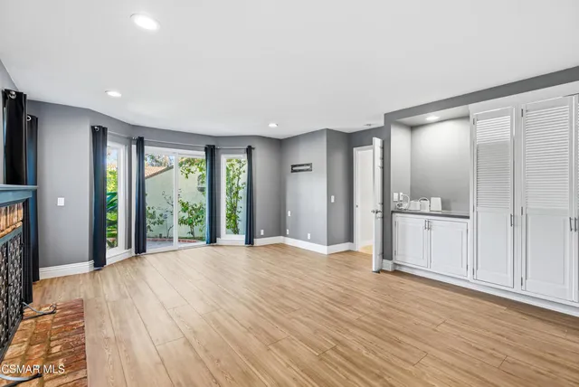 a front view of a house with a garden and yard