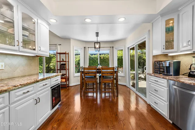 a kitchen with stainless steel appliances granite countertop counter space dining table and chairs