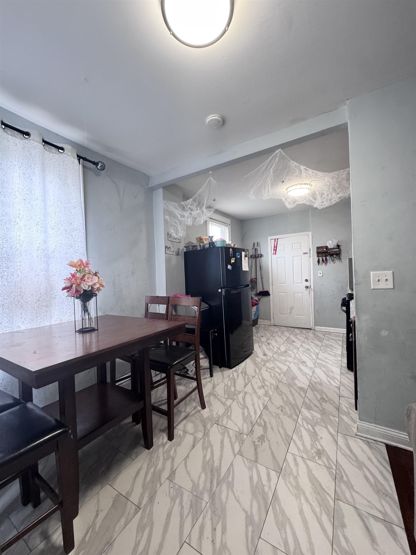 17 Green Court Lodi, NJ 07644 - Photo 8 of 21 a living room with furniture a dining table and a potted plant