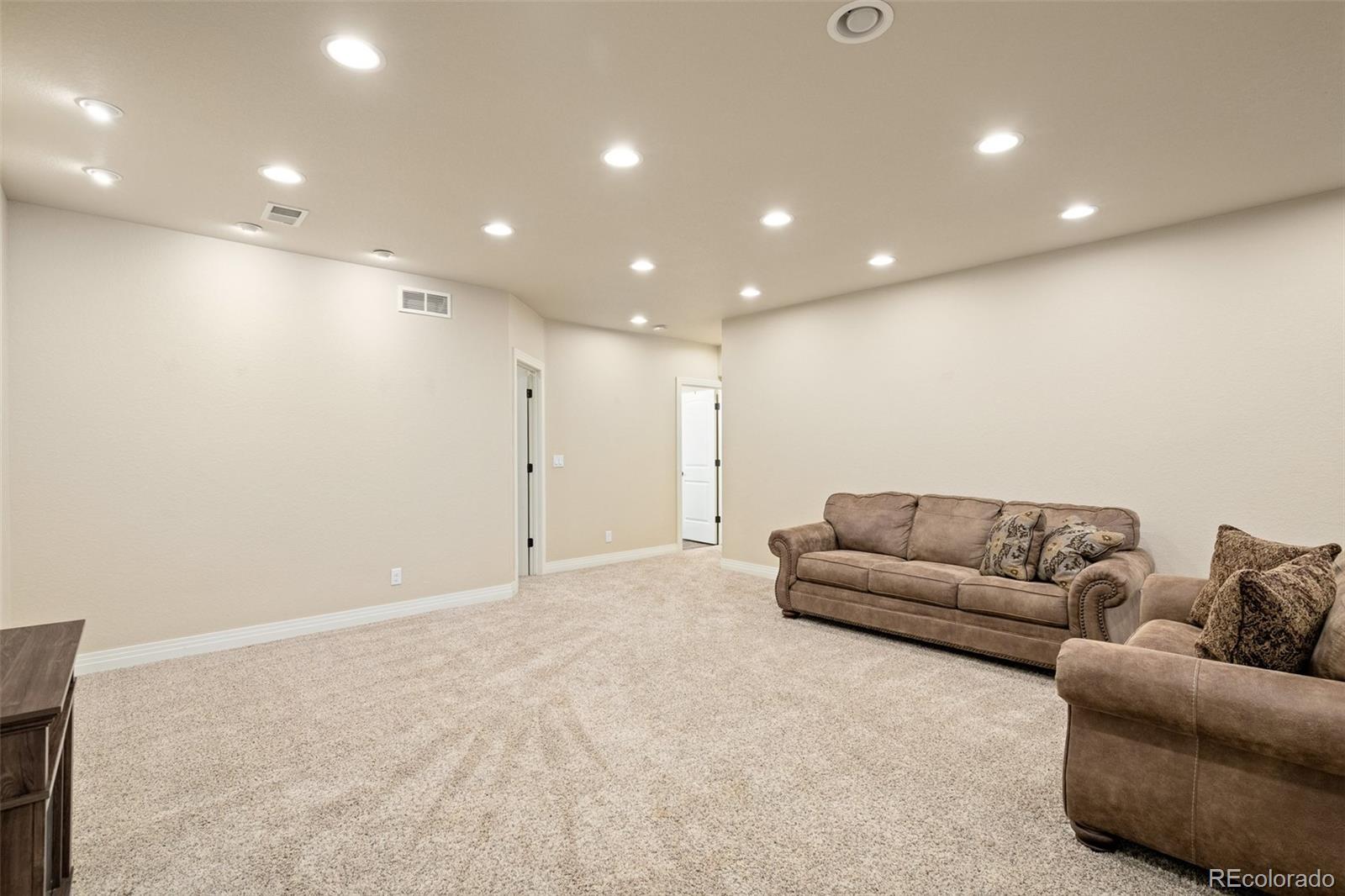 41865 East Muirfield Loop Elizabeth, CO 80107 - Photo 32 of 50 a living room with furniture and a couch