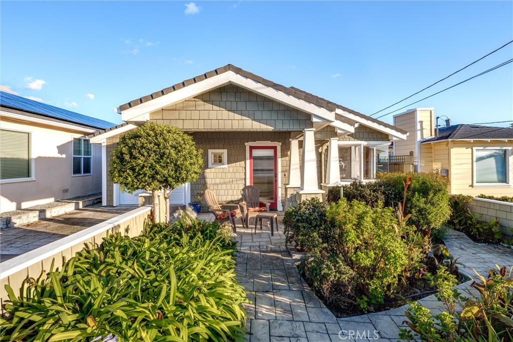 a front view of a house with garden