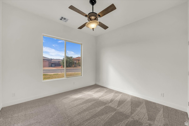 691 Rainier Drive St. George, UT 84770 - Photo 8 of 24 Empty room with light colored carpet and a ceiling fan