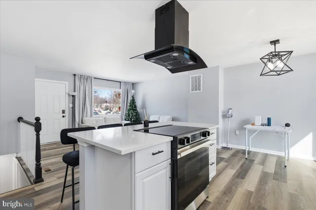 a kitchen that has a sink stainless steel appliances and cabinets