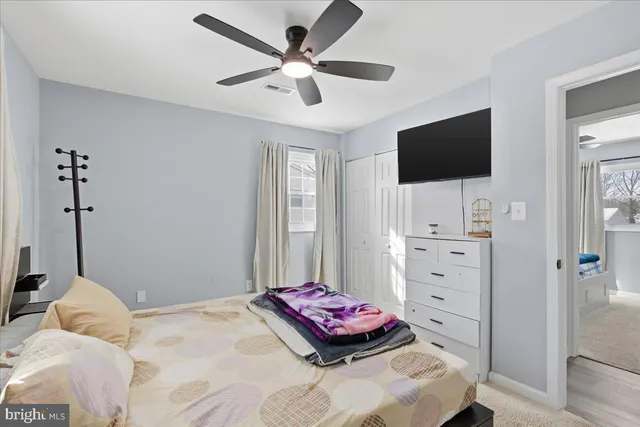 a bedroom with a bed and flat screen tv