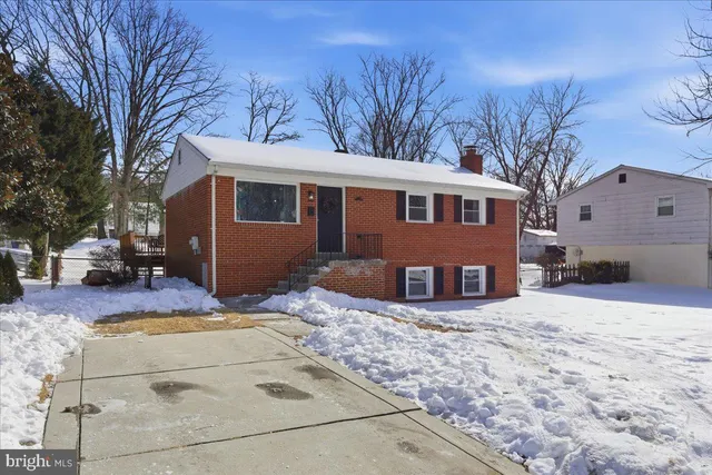 a view of a house with a yard covered in snow
