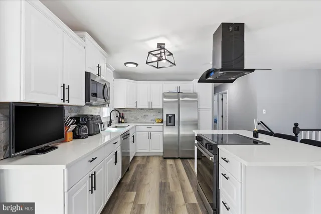 a kitchen with refrigerator and stove