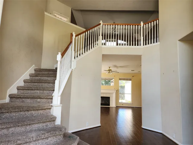 a view of entryway and hall with wooden floor