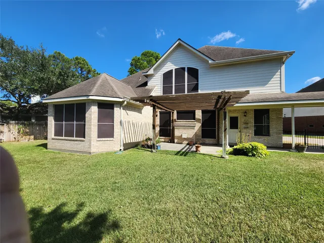 a view of a house with a yard patio and sitting area