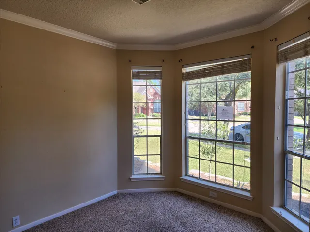 an empty room with large windows
