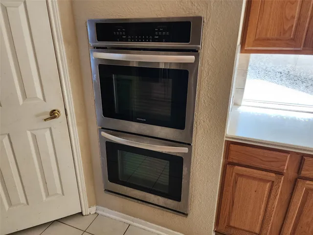 a stove top oven sitting inside of a kitchen