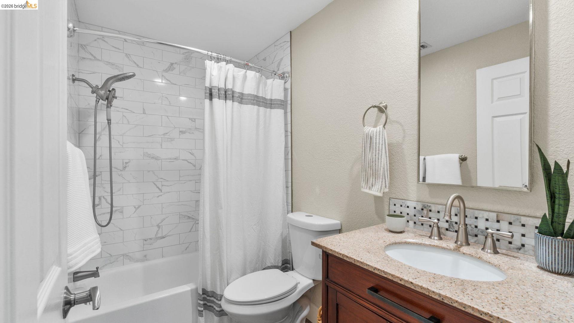 700 Brownstone Road Oakley, CA 94561 - Photo 29 of 58 a bathroom with a granite countertop sink toilet mirror and shower