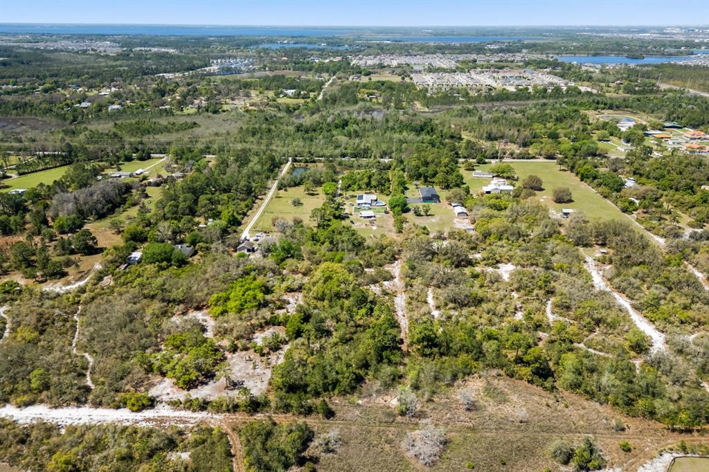 2727 Absher Road St. Cloud, FL 34771 - Photo 6 of 12 an aerial view of residential houses with outdoor space and trees