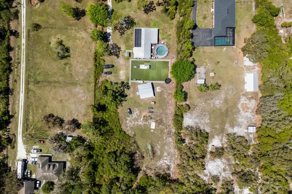 an aerial view of residential houses with outdoor space