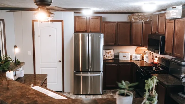 a kitchen with stainless steel appliances granite countertop a refrigerator and a stove