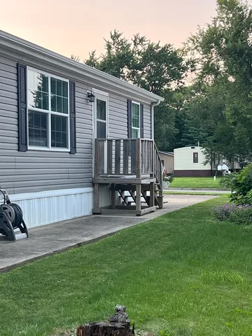 a view of a house with backyard sitting area and garden