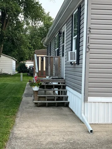 a wooden bench sitting in front of a house