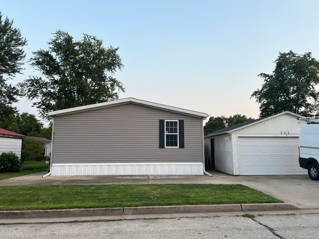 a side view of a house with a garage
