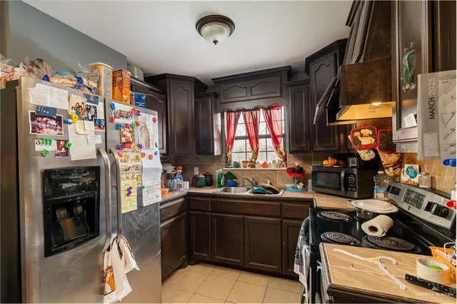 a kitchen with a sink stove and refrigerator